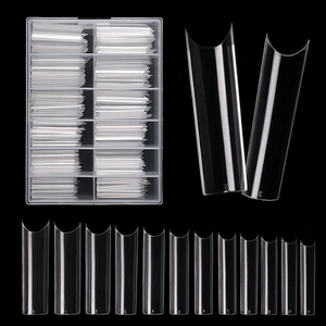 Macro detail of 240pcs clear C-curve extra long false nail tips in 12 sizes with storage box