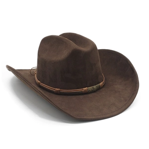 Detail of western cowboy hat with brown suede texture and skull metal buckle decoration