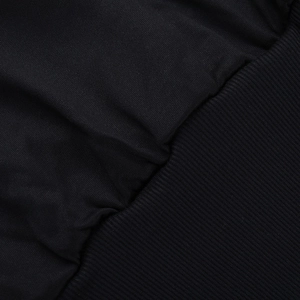 Macro detail of high-quality black knit fabric and elastic ribbed cuff on the sleeve