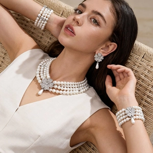 Baroque multi-layer pearl necklace set with rhinestone flower motifs and teardrop charms