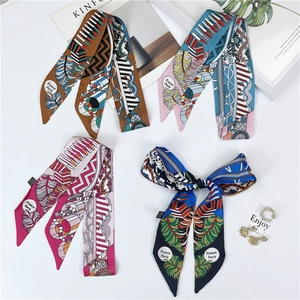 Flat lay of colorful geometric print silk scarves with France Paris lettering detail