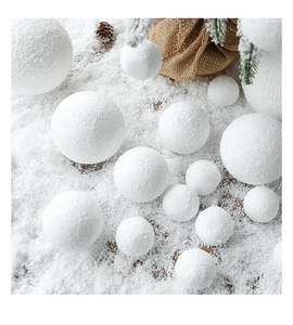 White foam snowballs of various sizes for Christmas tree decoration with pine cones