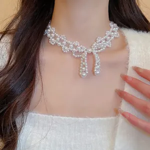 Elegant stainless steel bow pearl choker with intricate hollow weaving for women