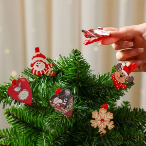 Christmas wooden clips featuring Santa, elk, and snowman motifs on a festive tree