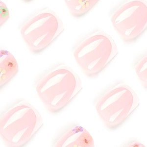 Short square press on nails featuring white French tips with delicate pink flower accents