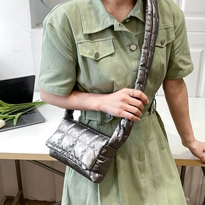 Silver quilted puffer crossbody bag shown on a model for size and style reference