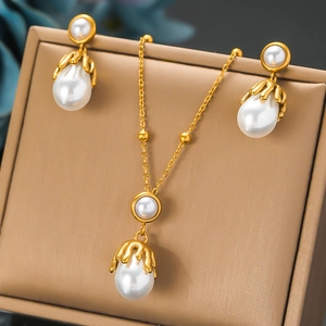 Irregular pearl jewelry set with melting gold accents including necklace and earrings