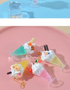 Detailed view of artificial fruit cream sundae charms with colorful macaron finishes