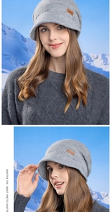 Detail view of grey knitted beanie with visor and leather patch in snowy landscape