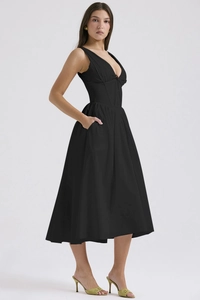 Detail shot of black deep V-neck maxi dress with cinched waist and functional side pockets