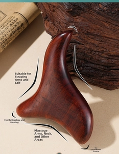 Macro shot of ergonomic sandalwood massage tool showing natural wood grain and rounded edges