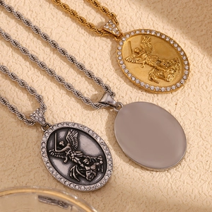 Detail of 18K gold and silver plated angel pendants with rhinestones on twist chains