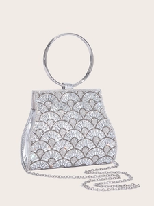 Macro shot of silver evening clutch with sparkling rhinestones and metal ring handle