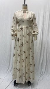 Detail of white long-sleeved dress with starfish sequins and hollow stand collar