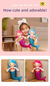 Close-up of plush mermaid dolls with sparkling sequin tails in pink and blue colors