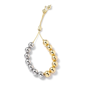 Detail of adjustable two-tone gold and silver beaded bracelet with sliding clasp mechanism