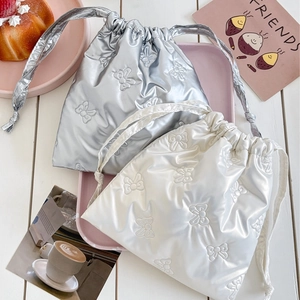 Waterproof drawstring pouch with bow embroidery in metallic silver and cream finish