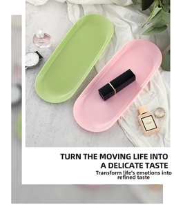 Macro detail of oval stainless steel jewelry trays in pink and green pastel finishes