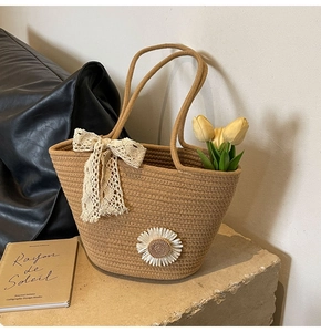 Detail of hand-woven tote bag with 3D daisy flower and lace ribbon bow decoration