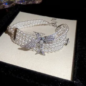 Bracelet multicouche en perles vintage français avec breloque hirondelle en zircon