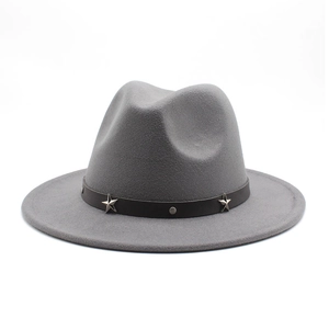 Detail of grey wide brim fedora hat with star studded black leather band trim