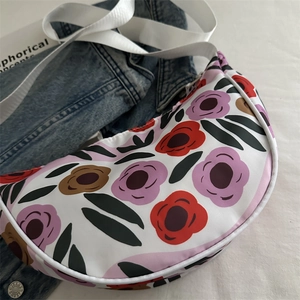Floral print large crescent shoulder bag with colorful pattern and adjustable strap
