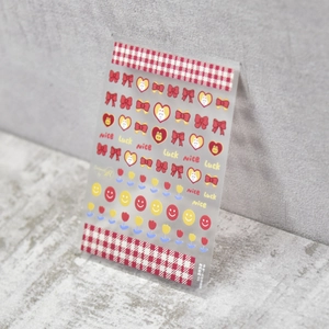 Close-up of 5D cute rabbit nail art stickers with red heart and bow patterns