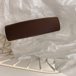 Detail of dark brown fabric headband with a premium twill texture and retro style