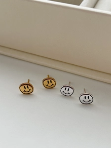 Détail macro de boucles d'oreilles smiley minimalistes en argent S925 or et argent