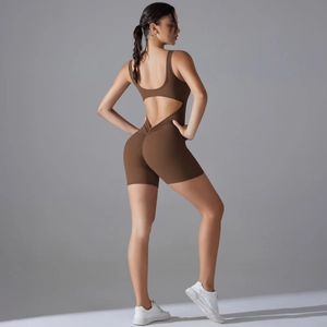 Detail of cross-waist back design and scrunch butt lifting effect on brown yoga romper