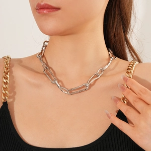 Detail view of silver irregular link chain necklace on model neck and collarbone