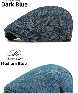 Detail view of denim beret hats in dark and medium blue with side metal buckles