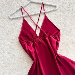 Deep V-neck burgundy satin nightgown with elegant cross back straps on white hanger