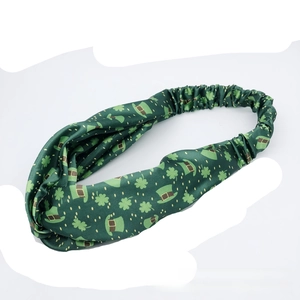 Detail of St. Patrick's Day headband with green shamrock and lucky hat print motifs