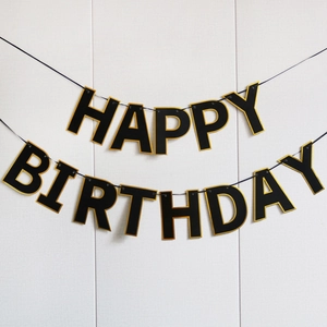 Daisy themed Happy Birthday paper banner in black and gold for kids party decoration