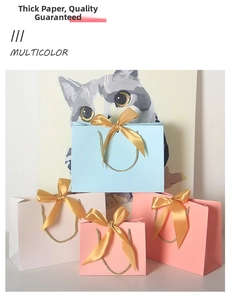 Detail of paper gift bags with golden satin bows and woven handles in multiple colors