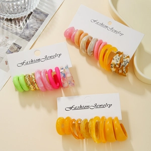 Detail of colorful acrylic hoop earrings on display cards with diverse resin textures