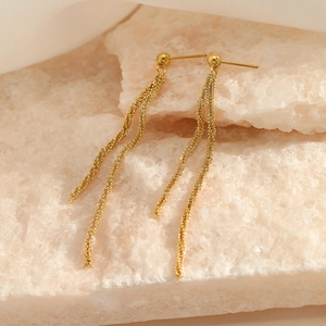Long gold tassel earrings with textured chain on pink stones, minimalist jewelry design