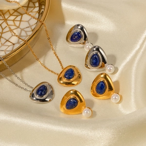 Lapis lazuli necklace and pearl earring set on silk fabric for a vintage French aesthetic