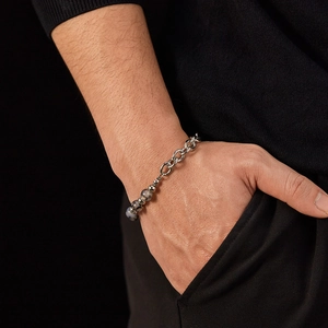 Close-up of a stainless steel beaded chain bracelet on a male model wrist