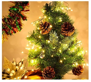 Warm white LED copper string lights intertwined with Christmas tree needles and pine cones