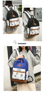 Detail view of printed floral canvas backpacks in black and blue with PU leather trim