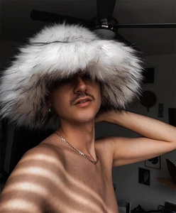 Detailed texture of thick faux raccoon fur hat in gradient black and white finish