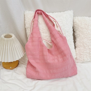 Close-up of pink textured cotton tote bag showing its soft fabric and inner lining