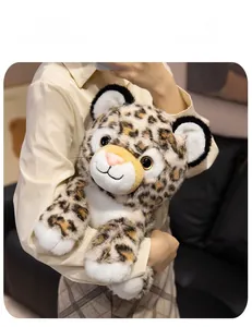 Close-up of cute leopard plush toy held by a model, showing soft spotted fur details