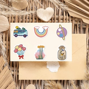 Close-up of colorful cartoon stickers featuring rainbow, sunflower and camper designs