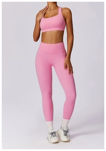 Detailed view of pink yoga set featuring racerback sports bra and high-waist leggings