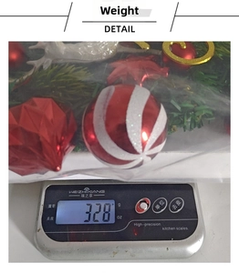 Detailed view of the Christmas wreath kit weight showing red baubles and deer ornaments