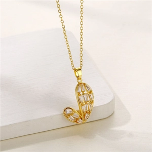 Detailed view of a gold-plated J-letter necklace pendant with sparkling zircon inlays