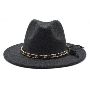 Detailed shot of dark grey wool felt hat with gold chain and black leather braid